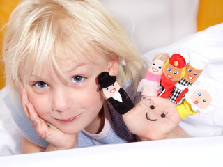 Cute little child plays with different finger puppets