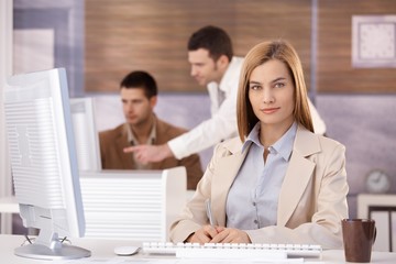 Pretty businesswoman at training course smiling