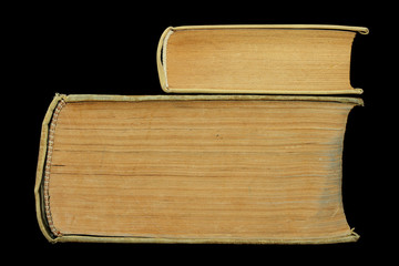 small old book on large old book isolated on black