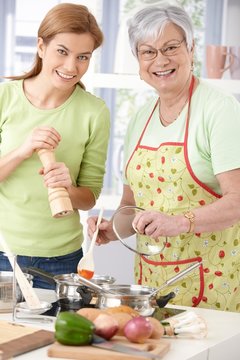 Happy mother and daughter cooking together