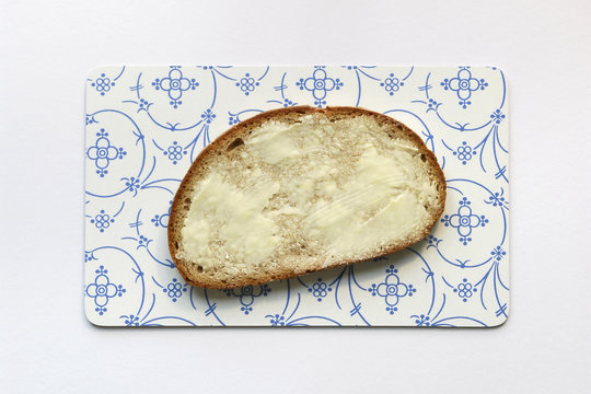 Slice Of Bread With Butter On Bread Board