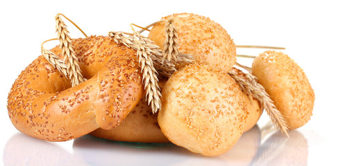 bread and buns with sesame seeds and spikelets isolated on white