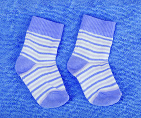 bright baby socks on blue background