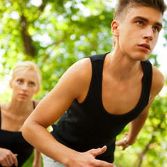Fototapeta premium Closeup Portrait of Young Couple Jogging In Park