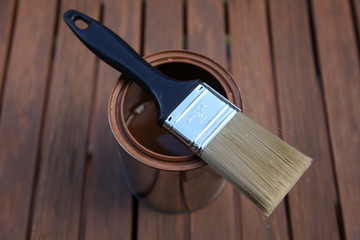 Clean paint brush, lying on a can, outside on patio