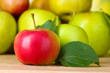 Many fresh organic apples on wooden table