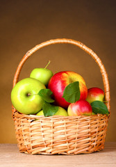 Basket of organic apples on brown background