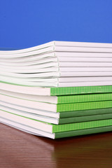 Pile of color magazines isolated on yellow background