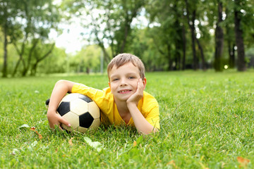 Little boy in the park with a ball