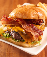 Bacon cheeseburger shot with selective focus - obrazy, fototapety, plakaty