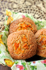 Three pumpkin muffins in a basket.