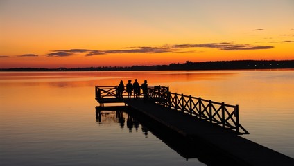 People on the pier at sunset