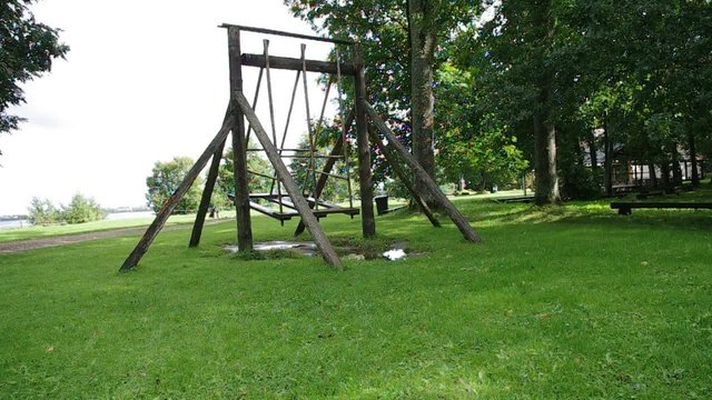 retro farm swing at a park in the summer