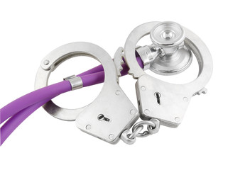 Stethoscope and handcuffs isolated on white background