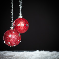 red christmas balls in front of dark background