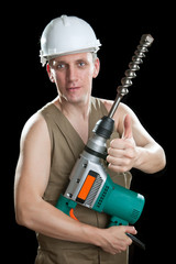 The builder in a protective helmet holds the  hammer