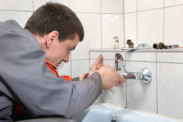 Plumber  fixing water pipe