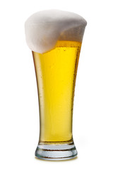 Beer into glass isolated on white