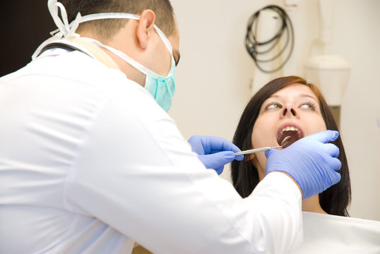 Image of a dentist curing a girl s teeth