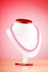 Pearl necklace against gradient background