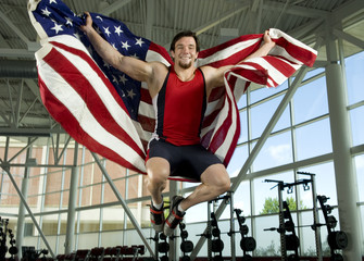 Caucasian athlete jumping with American flag