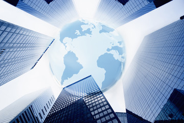 Large blue globe over highrise buildings