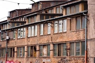 Fototapeta na wymiar Abandoned industrial building with brick wall
