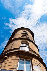 Fototapeta na wymiar Angle shot of a tall building with blue sky
