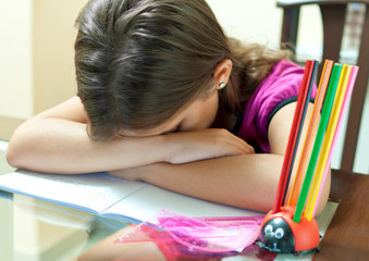 Young girl asleep after studying for an exam