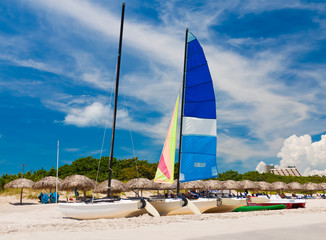 Umbrellas and catamaran on Varadero beach in Cuba