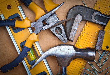 Set of tools over a wood panel