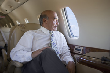 Hispanic businessman on private jet