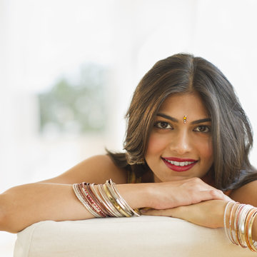 Mixed race woman wearing bindi and bangles