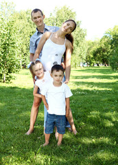 Fototapeta premium Family with two children in the summer park