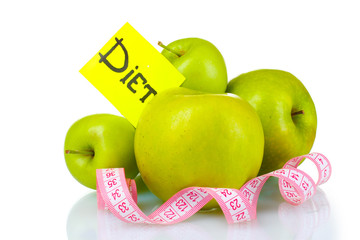 ripe green apples and measuring tape isolated on white