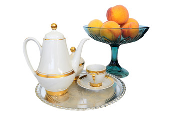 Coffee set on silver tray and bowl of appricots