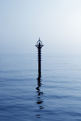 Obraz premium backlight beacon in Mediterranean blue sea reflection