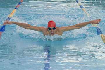 Hispanic man swimming in swimming pool