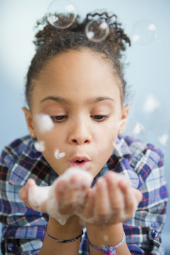 African American girl blowing bubbles