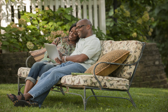 African American couple using digital tablet outdoors