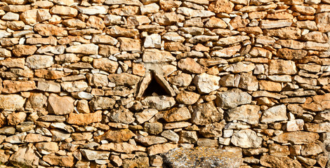 aged masonry stone wall triangle window hole
