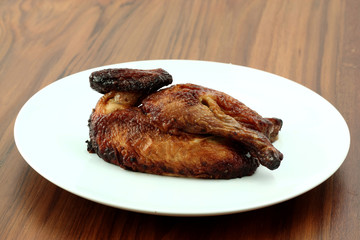 roasted chicken in wood background