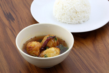 Thai food boiled egg fried with tamarind sauce and rice in wood