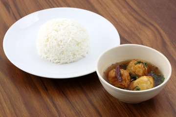 Thai food boiled egg fried with tamarind sauce and rice in wood