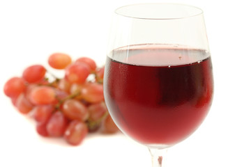 Red wine glass with grape isolated on white background