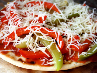 Pita bread pizza with veggies and mozzarella cheese