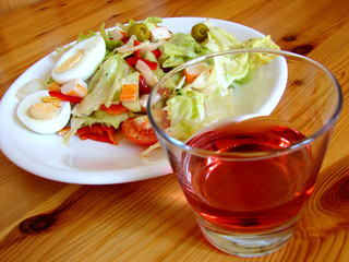 salad mediterranean and a pink wine glass