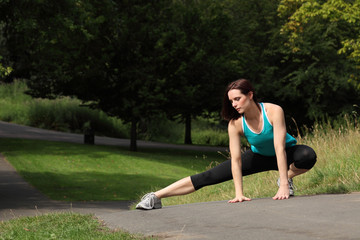 Beautiful fit athletic woman warm up stretch