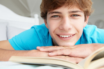 Teenage boy reading a book