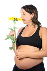 pregnant woman with beautiful belly and sunflower